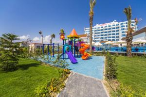 a playground at the beach with a hotel in the background at Sun Star Resort Hotel in Alanya
