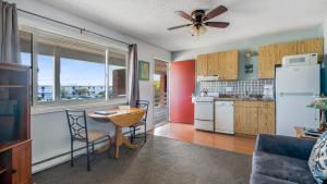 a kitchen with a ceiling fan and a table and chairs at Montauk Oceanside Suites in Montauk
