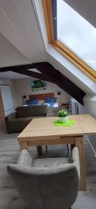 a wooden table and chairs in a living room at Pension am Lieserpfad in Manderscheid