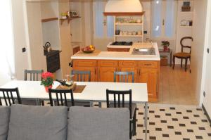 a kitchen with a table and chairs in a kitchen at Sea Apartment in Sanremo