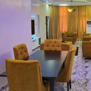 a dining room with a table and chairs at S&A Lump Apartments, Enugu, Nigeria in Enugu