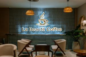 a coffee shop with a sign on the wall at La Beaute Hotel - Quy Nhơn in Quy Nhon