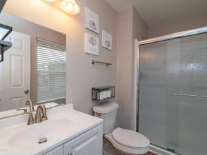 a bathroom with a toilet and a sink and a shower at Chic & Spacious 3br2ba Home In Pecan Lake in Little Rock