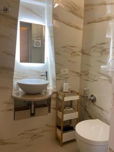 a bathroom with a sink and a toilet at Eureka luxury room in Ostuni +10 photos