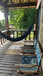 a hammock on the porch of a house at Mansão Espetacular Angra in Angra dos Reis
