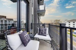 a balcony with two chairs and a view of a street at Vesta - Odyssey - Heart of Midtown in Nashville