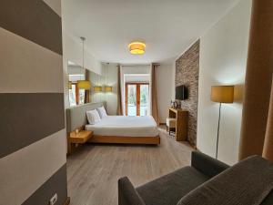 a hotel room with a bed and a couch at Vistadouro 2 in Peso da Régua