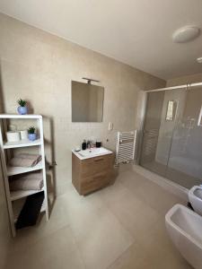 a bathroom with a sink and a toilet and a shower at Parkside Apartments Praha in Prague