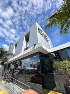 a building with a car dealership on a street at Mcz Hotel in Maceió