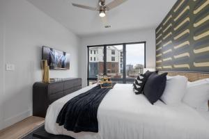 a bedroom with a large bed and a large window at Wonderstruck - Odyssey - Heart of Midtown in Nashville