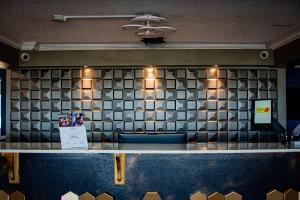 a counter in a restaurant with a tiled wall at Super 8 by Wyndham Biloxi at the Beach in Biloxi