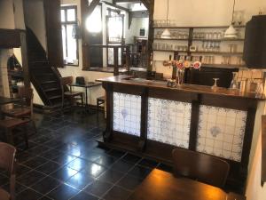 a bar in a restaurant with chairs and tables at De Pelgrim in Tongeren