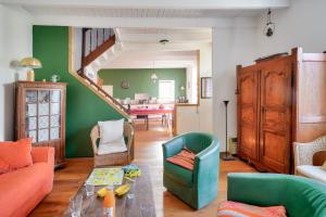 a living room with a couch and chairs and a table at À 700m de la plage, charmante maison pour 6 in Kersuluan +10 photos