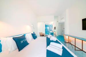 a room with a bed with blue and white pillows at Hotel Villa Durrueli Resort & Spa in Ischia