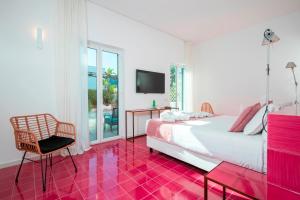 a bedroom with a bed and a red tiled floor at Hotel Villa Durrueli Resort & Spa in Ischia