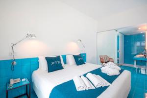 a hotel room with two beds with towels on them at Hotel Villa Durrueli Resort & Spa in Ischia