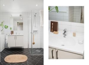 a white bathroom with a shower and a sink at Central City Apartment in Bergen