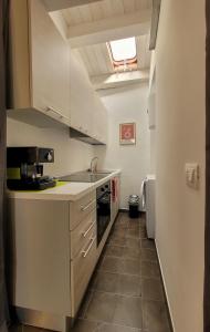 a kitchen with a sink and a stove at B&B Loft Famiglia Arezzo in Ragusa