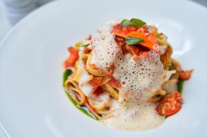 a plate of pasta with sauce and pepperoni at The Nici in Bournemouth