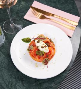 a white plate with food on a table at The Nici in Bournemouth