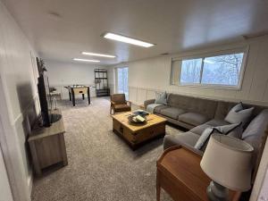 a living room with a couch and a table at Cozy Mountain Retreat in Morgan