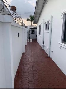 a hallway of a house with a red brick sidewalk at Kings Lux Home in Lagos