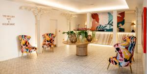 a room with two chairs and a table with flowers at The Nici in Bournemouth
