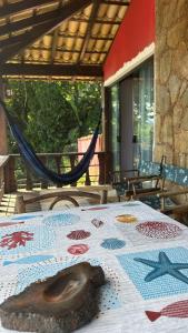 a table with a table cloth with a sculpture on it at Mansão Espetacular Angra in Angra dos Reis
