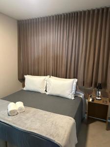 - une chambre avec un lit et 2 oreillers blancs dans l'établissement Hotel Cabana, à Caetanópolis