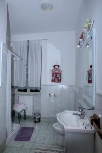 a white bathroom with a sink and a toilet at La Terrazza in Tuscania