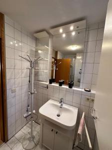 a white bathroom with a sink and a mirror at La Luna in Beuren