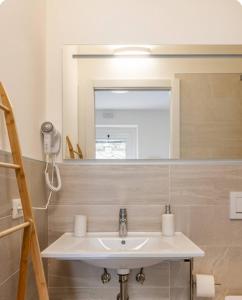 a bathroom with a sink and a mirror at Vittoria room in Bardolino
