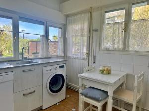 a kitchen with a washing machine and a sink at Chalet Pitu - 17801 in Piedrahita