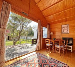 a dining room with a table and chairs and a large window at Chalet Pitu - 17801 in Piedrahita