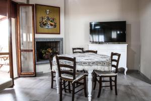 uma sala de jantar com uma mesa e cadeiras e uma televisão em Villa Raffaella em Selvatelle