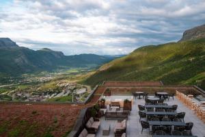 a patio with tables and chairs on top of a mountain at Skarsnuten Hotel and Spa by Classic Norway Hotels in Hemsedal