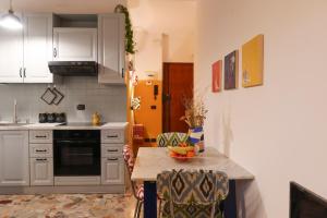 a kitchen with a table with a bowl of fruit on it at Sancisi 3 in Santarcangelo di Romagna
