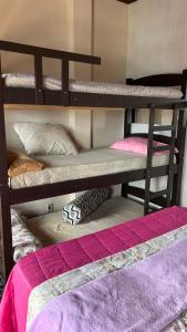 two bunk beds in a room with at Mansão Espetacular Angra in Angra dos Reis