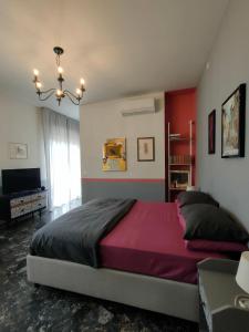 a bedroom with a large bed and a television at Zeljko's luxury hostel in Vicenza