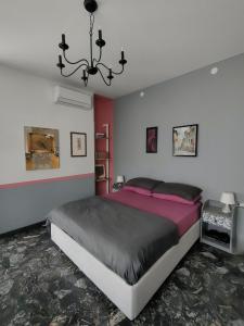a bedroom with a large bed and a chandelier at Zeljko's luxury hostel in Vicenza