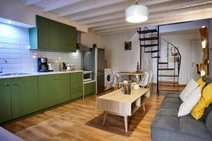 a kitchen and a living room with a couch and a table at The Wine House in Chios