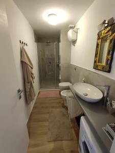 ein Badezimmer mit 2 WCs, einem Waschbecken und einer Dusche in der Unterkunft La casa di Fabri in Piombino