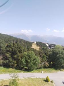 a view of a mountain with a road and trees at Appartement avec belle vue sur montagne in Égat