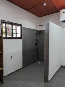 a bathroom with a shower in a room at Casa Lamar in Sanyang