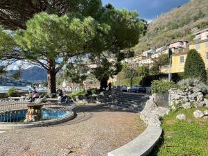 a park with a tree and stairs in a town at Lake Front View on Viale GENO in Como