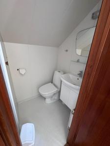 a small bathroom with a toilet and a sink at Setrið Guesthouse in Borgarnes
