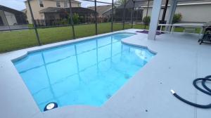 a swimming pool with blue water in a building at Kildrummy Lux Apartment in Davenport