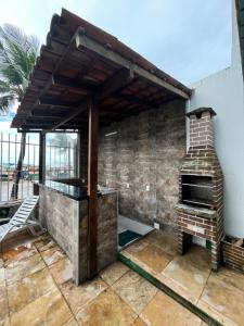 an outdoor kitchen with a pizza oven on a patio at Sonho de Iracema Hostel Boutique in Fortaleza