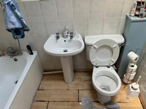 a bathroom with a toilet and a sink at Hastings street in Luton