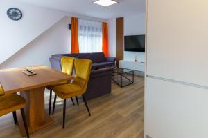 a living room with a table and a couch at Haus der Sonne in Soltau